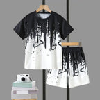 Boys' Summer Set: Cool Black & White Round-neck T-shirt with Slanted Pocket, Paired with Matching Shorts for Casual Play.