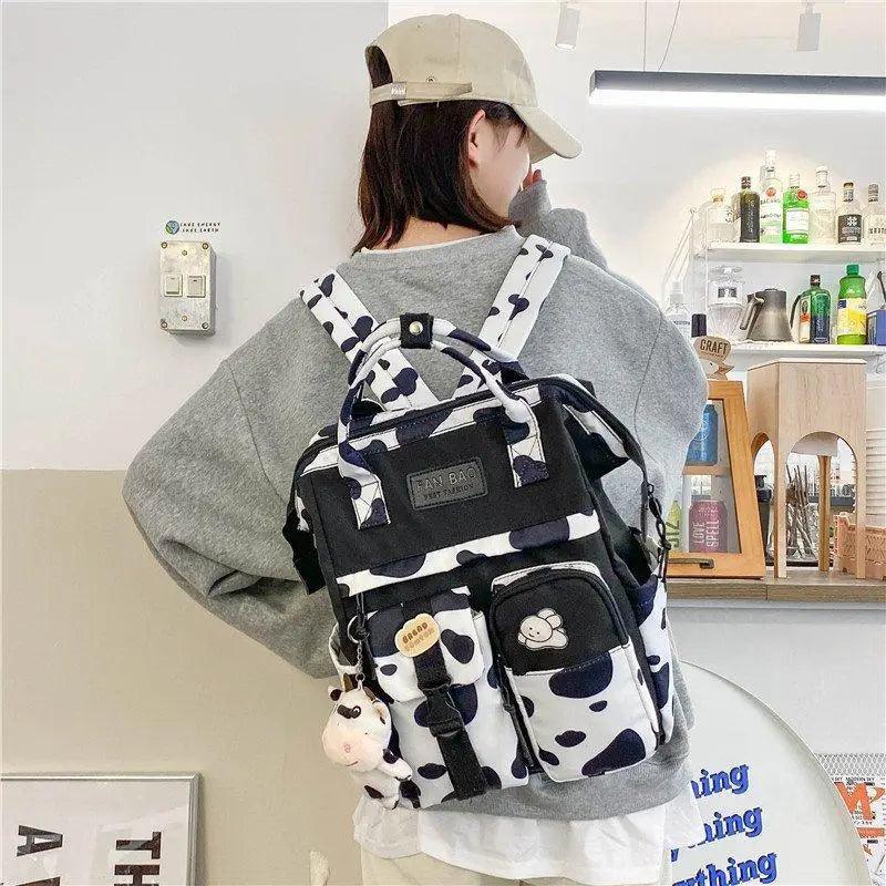 New Trendy Casual Women Purple Backpacks Fashionable Black Cow Pattern Travel Bag And School Bag for Teenager And Girls Stevvex