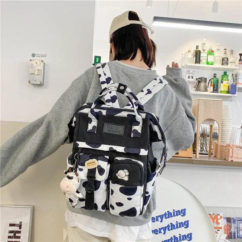 New Trendy Casual Women Purple Backpacks Fashionable Black Cow Pattern Travel Bag And School Bag for Teenager And Girls Stevvex